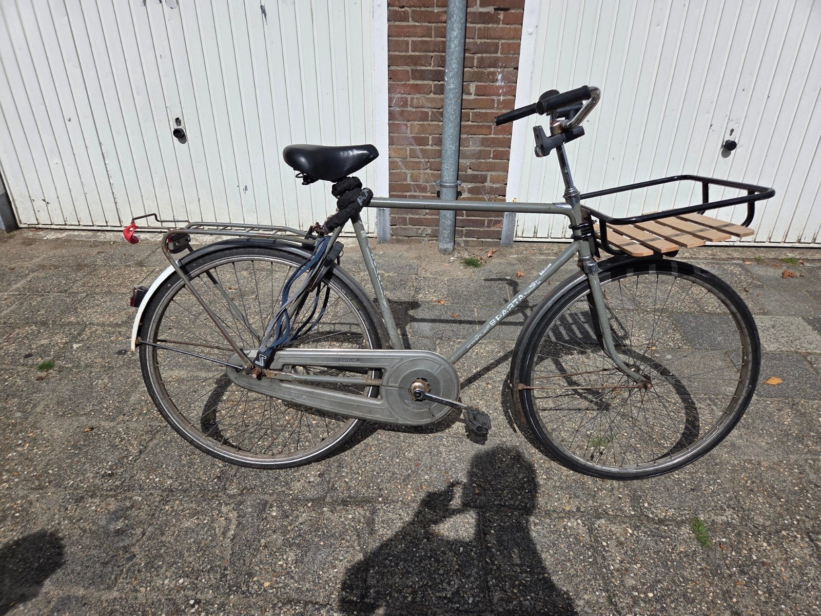 Degelijke Sparta stadsfiets met voordrager, Ophalen, Terugtraprem, Sparta, Gebruikt
