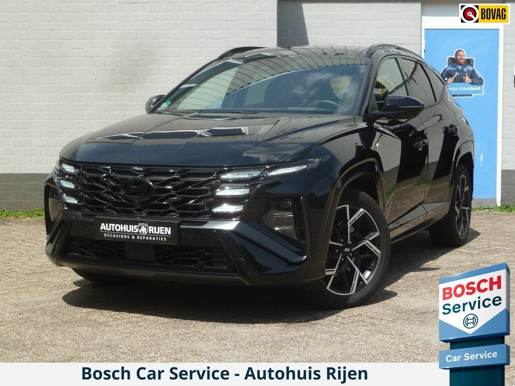 Hyundai Tucson 1.6 T-GDI HEV N Line Sky 4WD|Panodak|Stoelkoe, Auto's, Hyundai, Automaat, Gebruikt, Zwart, 4 cilinders
