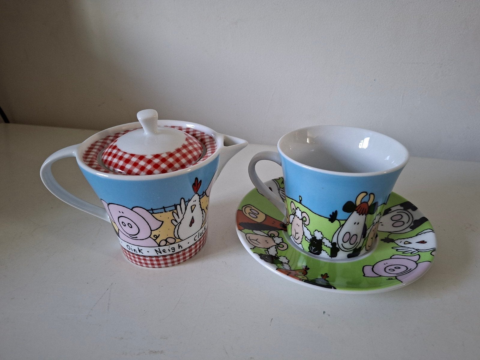 Theepot één persoon kop en schotel met boerderijdieren, Ophalen of Verzenden, Zo goed als nieuw, Overige stijlen, Kop(pen) en/of Schotel(s)