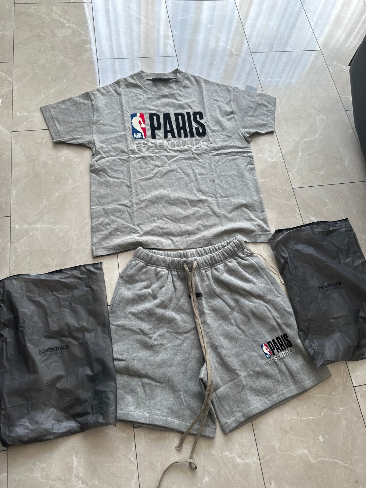 Fear of God Essentials NBA Paris T-shirt & Short Set, Ophalen of Verzenden, Nieuw, Maat 46 (S) of kleiner, Grijs