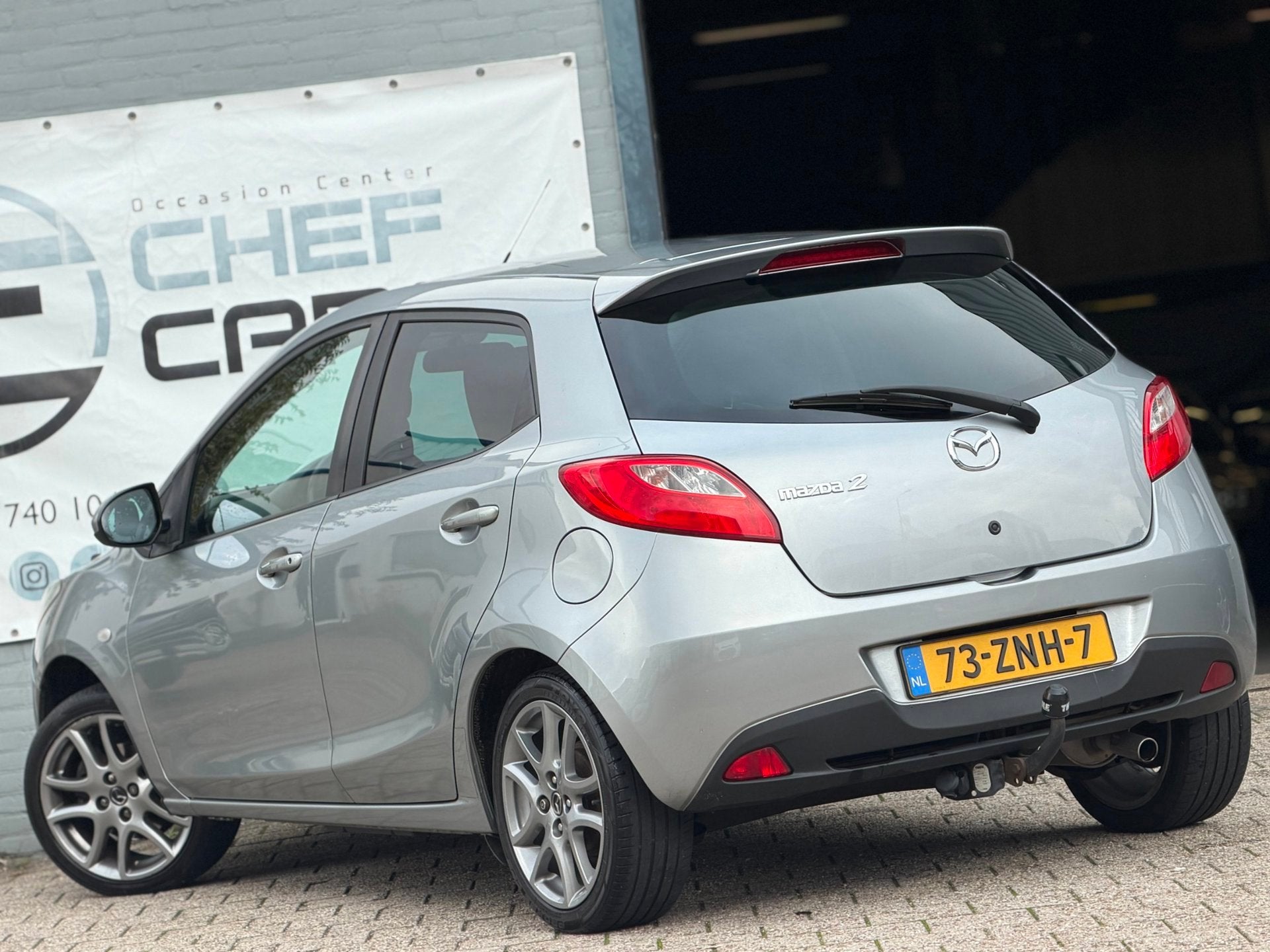 Mazda 2 1.3 GT|NAP|AIRCO|5DEURS|BOEKJES|STOELVW|LM|TREKHAAK!, Voorwielaandrijving, Euro 5, Zwart, 4 cilinders