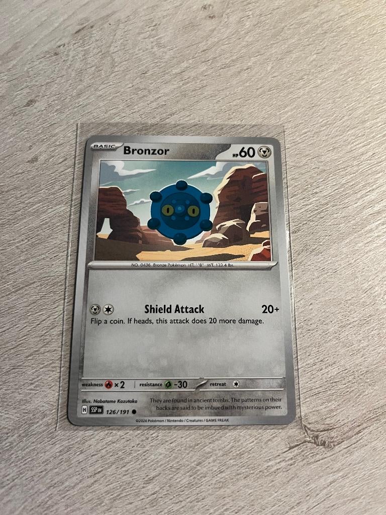 Bronzor 126/191 Surging Sparks - Pokémon Kaart, Ophalen of Verzenden, Nieuw, Losse kaart