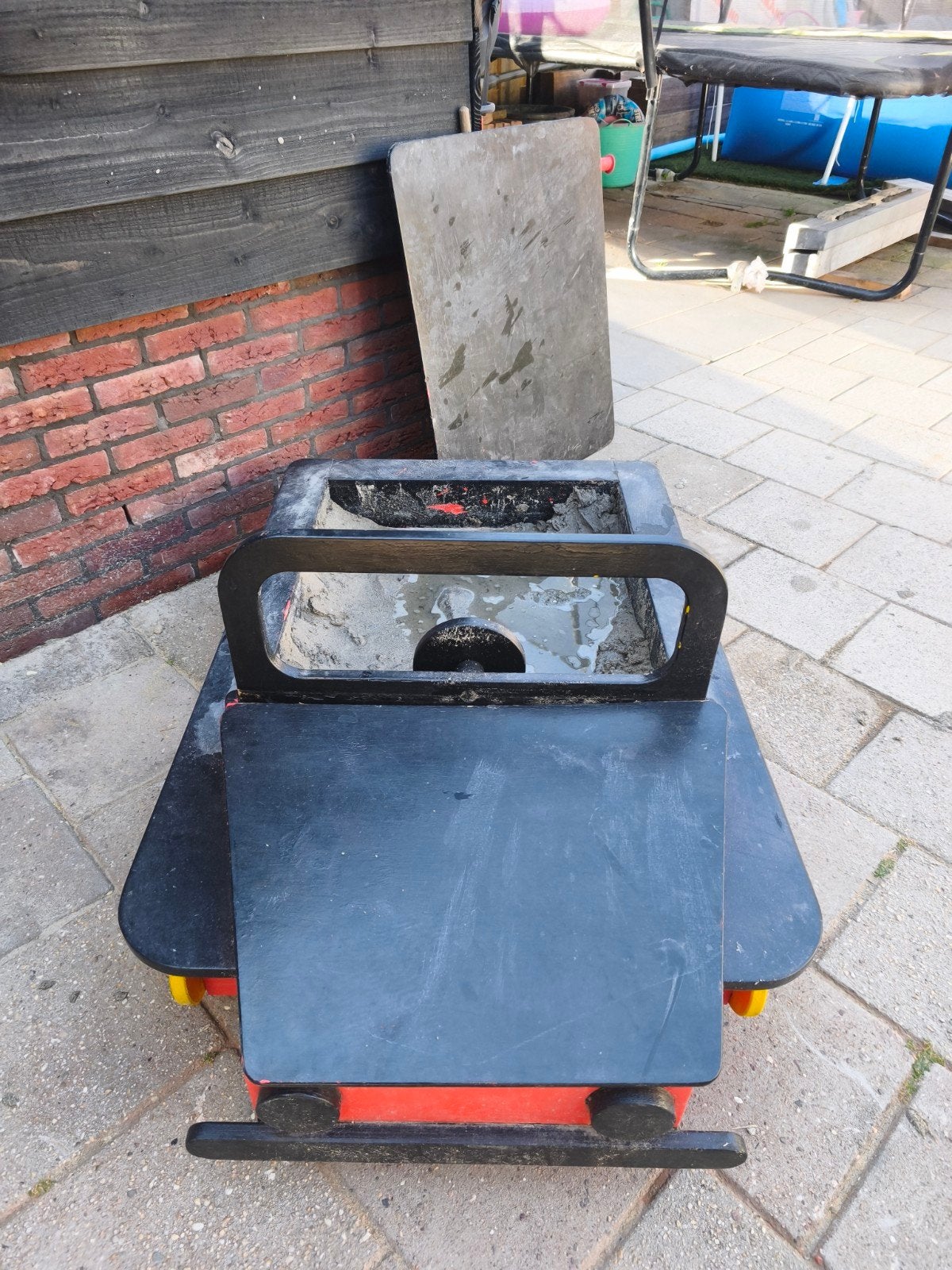 Auto zandbak met opbergruimte, Ophalen
