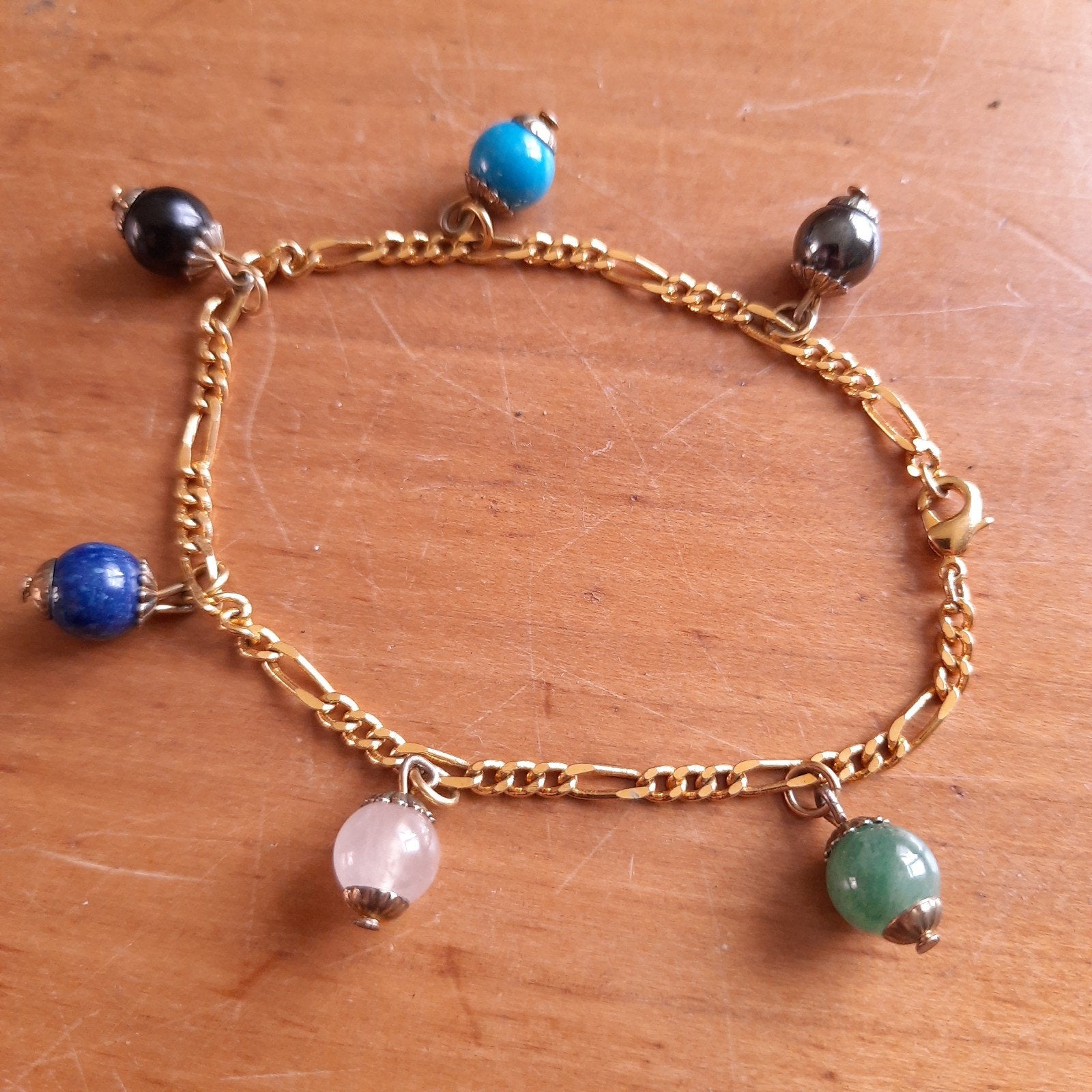 Vergulde Armband met Zes Bedels Natuursteen, Verzenden, Zo goed als nieuw, Overige materialen