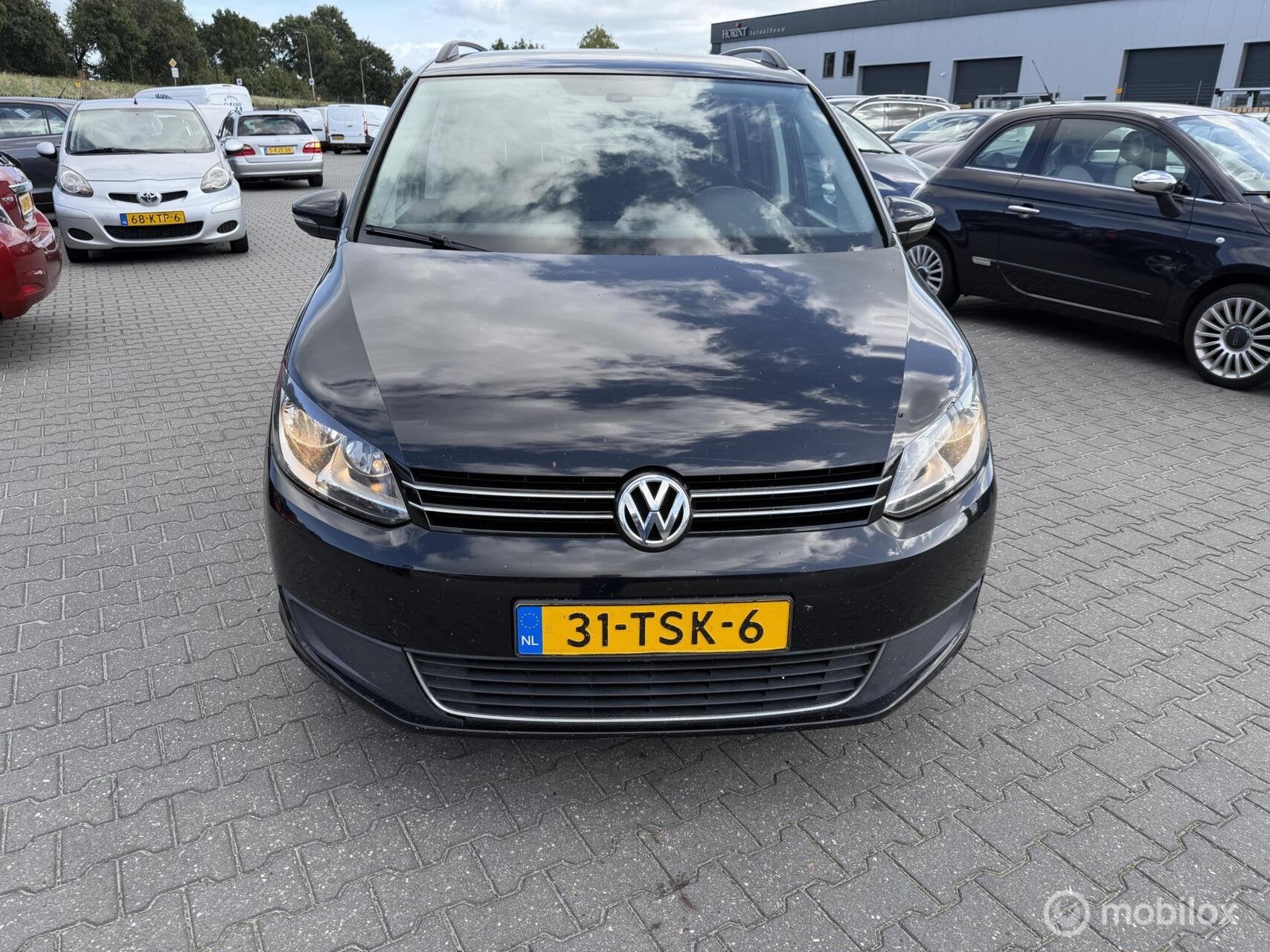 Volkswagen Touran 1.6 TDI Highline BlueMotion, Auto's, Euro 5, Stof, Gebruikt, Zwart