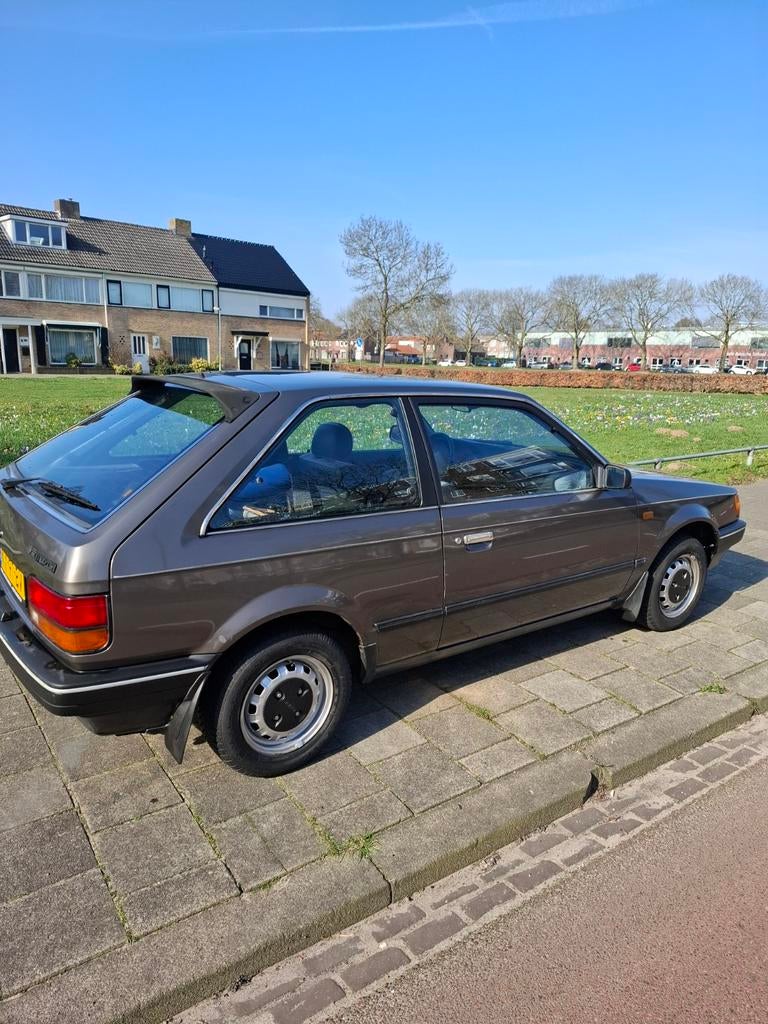 Mazda 323 1.3 HB 1985 Grijs, Auto's, 4 cilinders, 400 kg, Origineel Nederlands, Overige kleuren