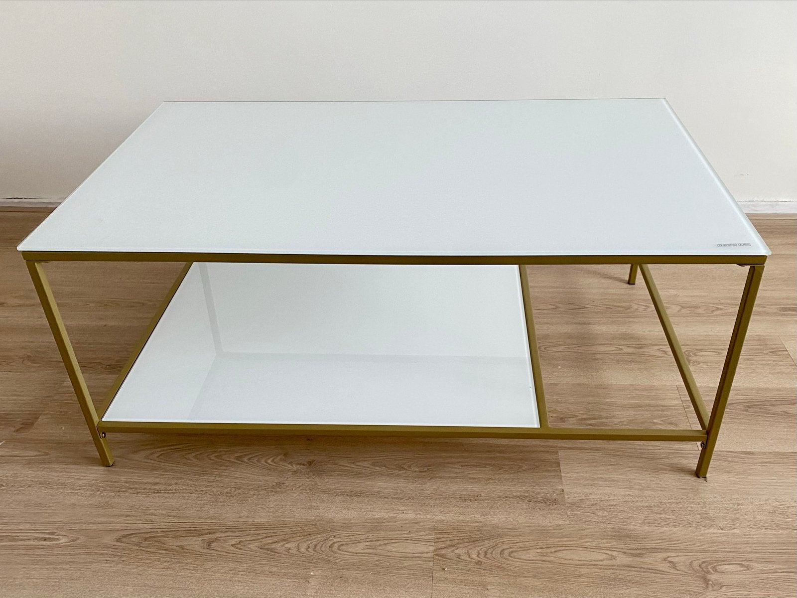 salontafel met wit glazen blad en gouden frame, Ophalen, 50 – 75, 100 tot 150 cm, 50 tot 100 cm