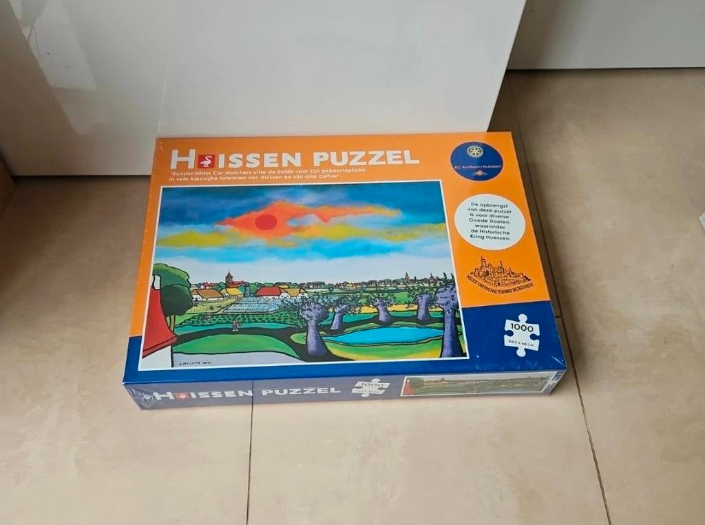 Huissen Puzzel 1000 stukjes - Cor Melchers Kunstwerk, Ophalen of Verzenden, Meer dan 50 stukjes, Nieuw, 6 jaar of ouder