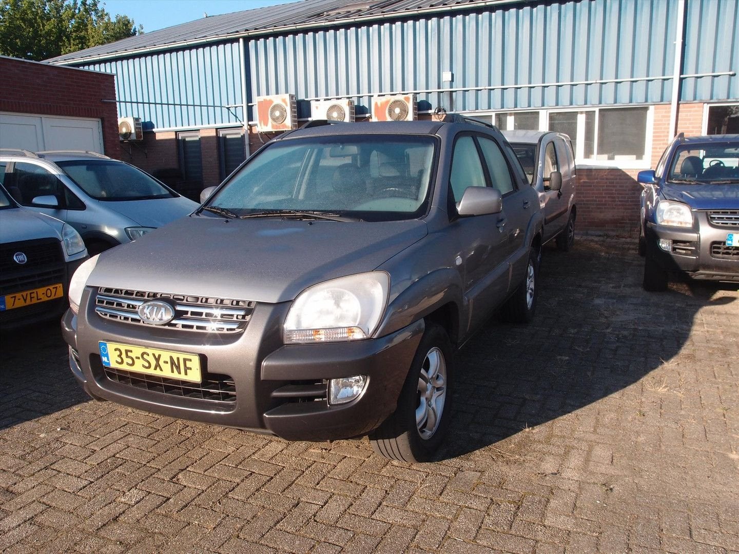 Kia Sportage 2.0 CVVT 4WD Adventure 1e Eign Export prijs, Auto's, Kia, Zwart, 4 cilinders, 139 pk, Metallic lak