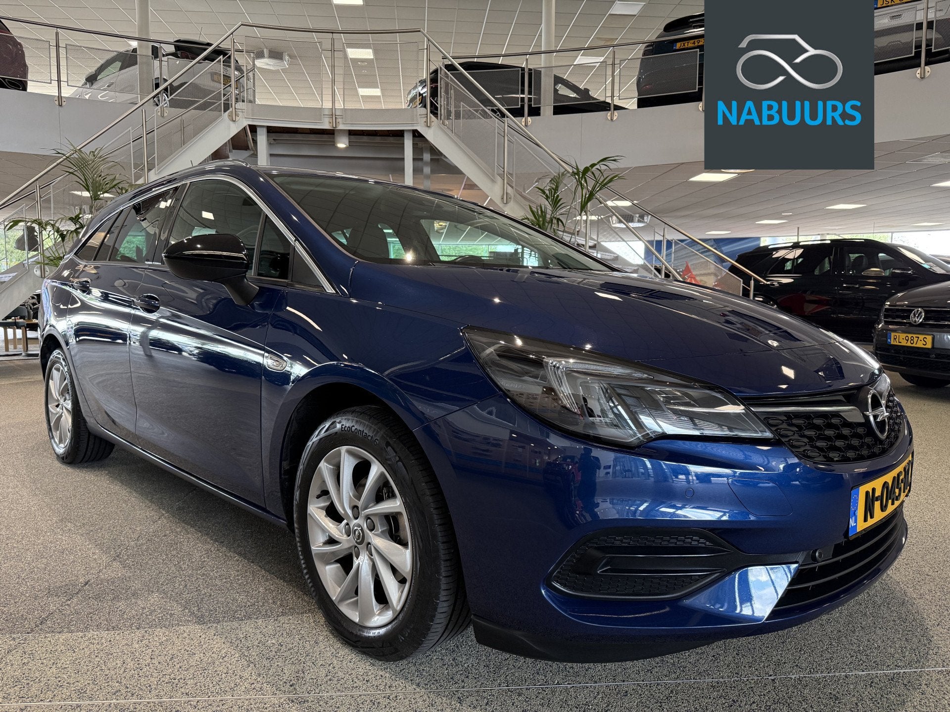 Opel Astra Sports Tourer 1.2 Business Elegance NL auto, Trek, Auto's, Voorwielaandrijving, 12 maanden, Euro 6, Blauw