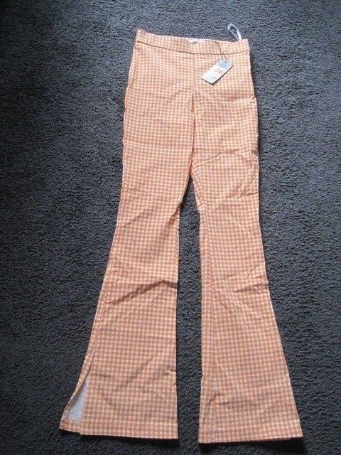 Wijde broek. Nieuw. Primark. Maat 36. Totale lengte 105 cm., Primark, Nieuw, Oranje, Ophalen of Verzenden