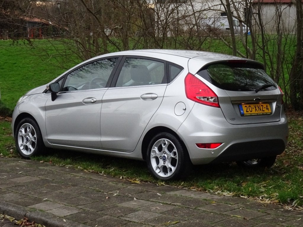 Ford Fiesta 1.25 Titanium met Airco en Radio (bj 2012), Keurmerk '100% Onderhouden', Euro 5, Stof, 1242 cc