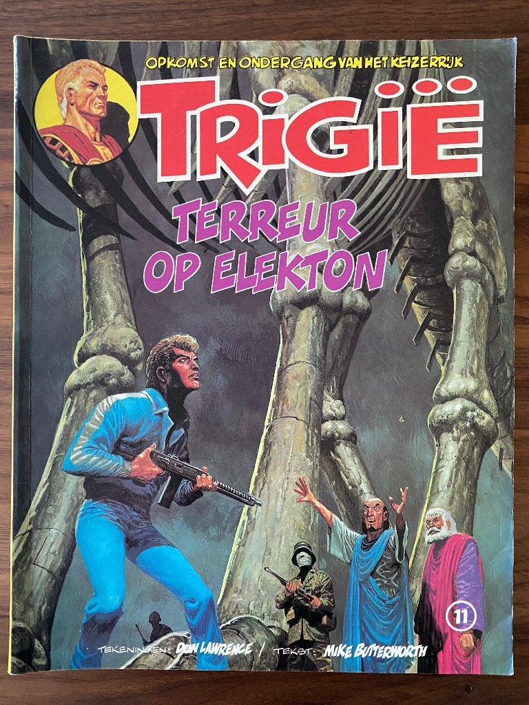 Trigië (11) Terreur Op Elektron, Gelezen, Ophalen of Verzenden, Don Lawrence, Mike Butterworth, Eén stripboek