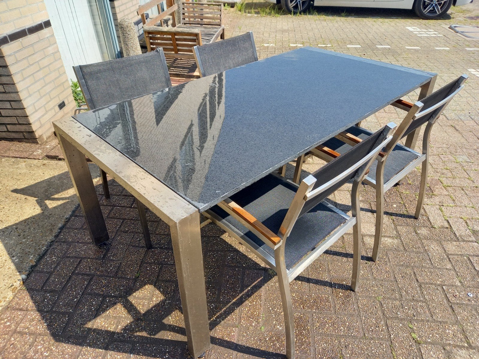 Moderne rvs tuinset met 4 stoelen en granieten tafelblad, Ophalen, 4 zitplaatsen, Gebruikt, Rvs