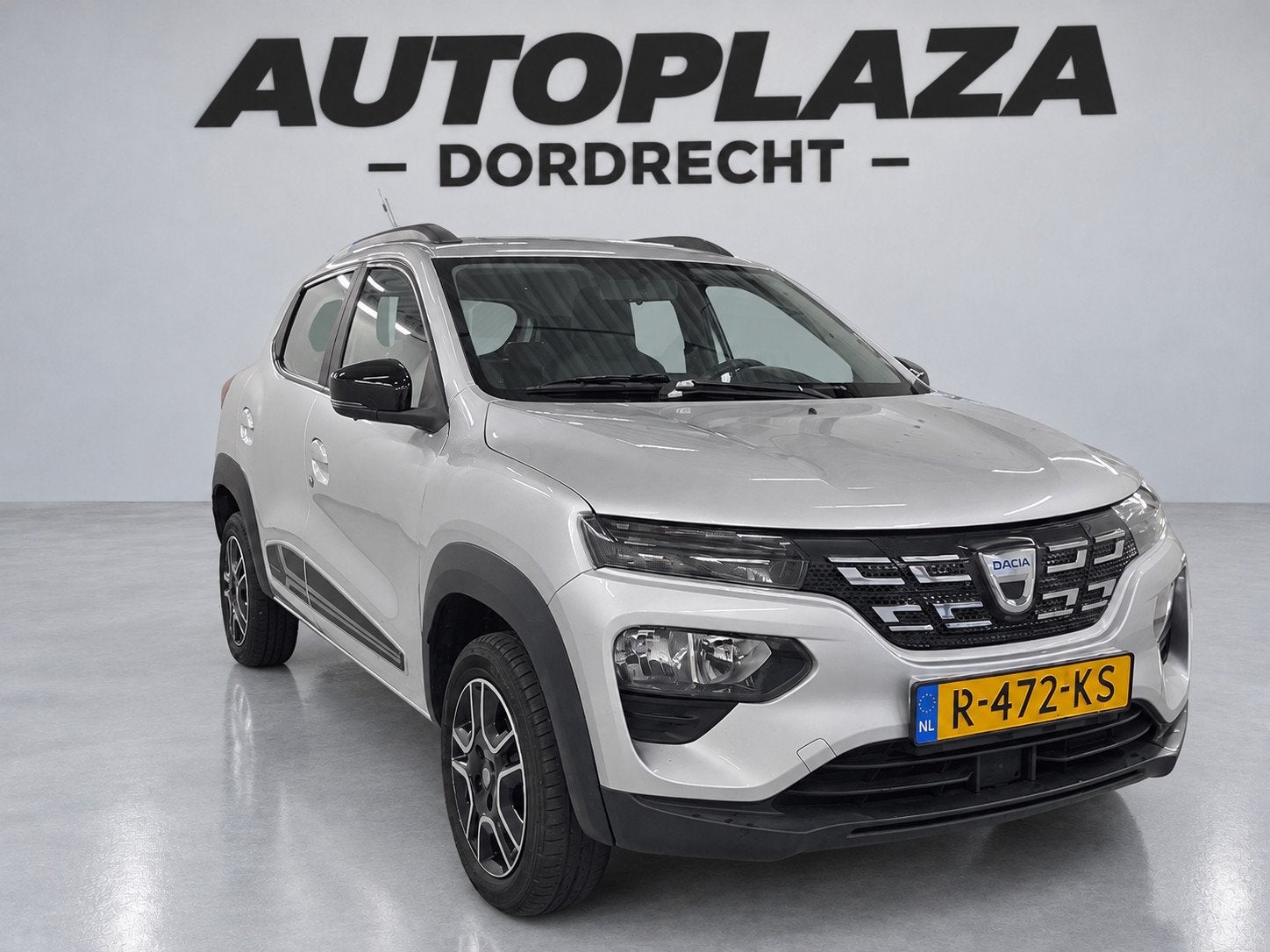 Dacia Spring Comfort Plus (Orange Pack) 27 kWh- SOH 89% |Cam, Auto's, Dealer onderhouden, Stof, Gebruikt, 230 km
