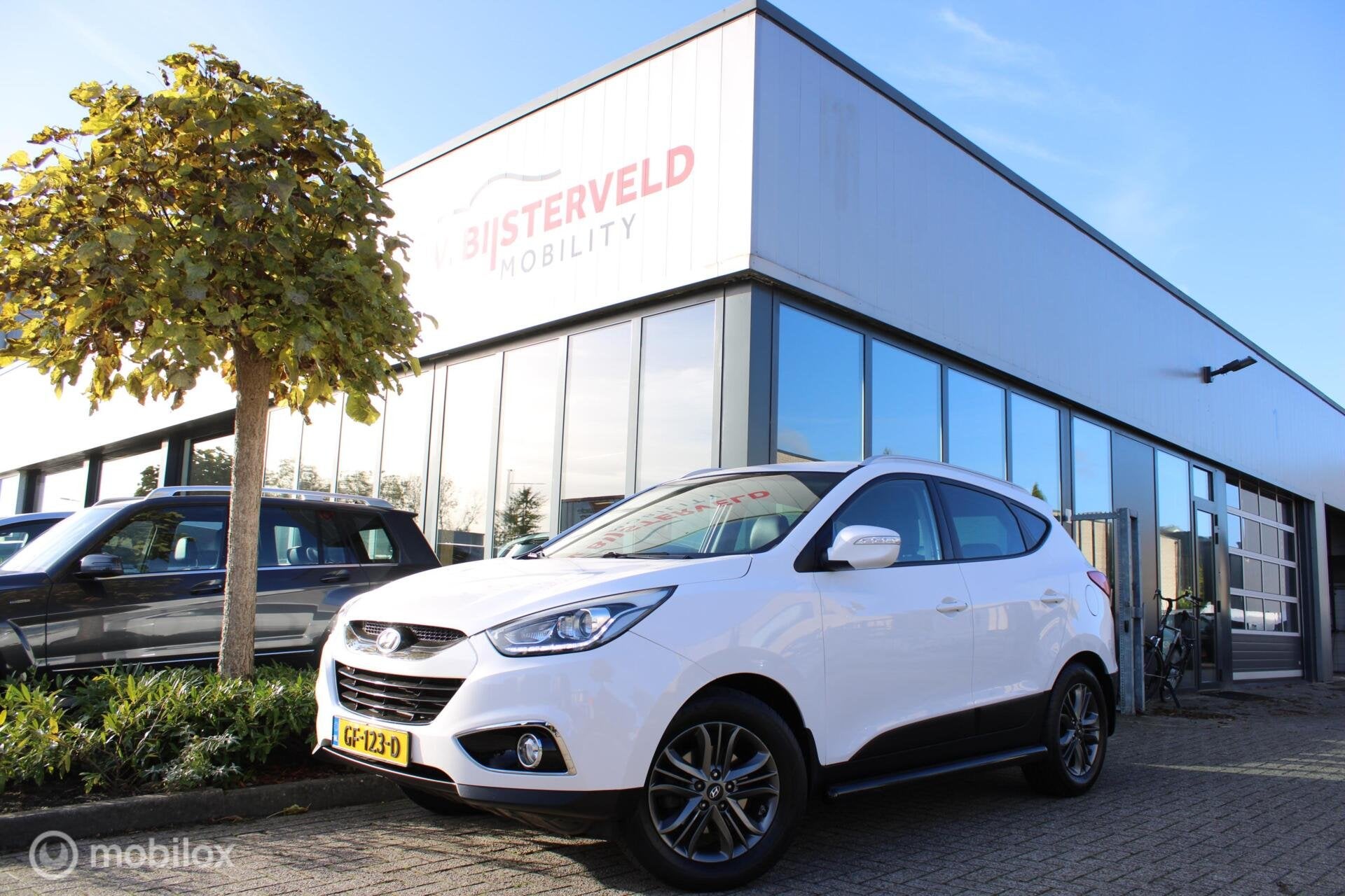 Hyundai ix35 1.6i GDI Go! Camera|Navi|Half-leder|NL-Auto, Auto's, Voorwielaandrijving, Euro 5, 4 cilinders, Wit