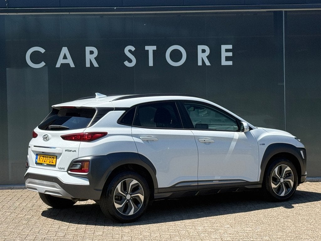 Hyundai Kona 1.6 GDI HEV Fashion Navi|Carplay|Stoelver|Dodeh, Auto's, Hyundai, Stof, Gebruikt, Automatische klimaatregeling, Wit