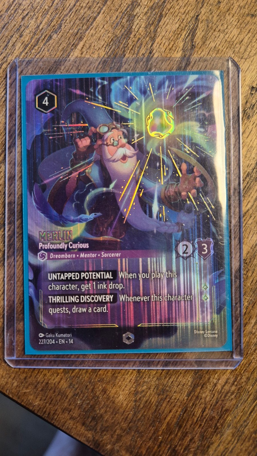 Disney Lorcana Enchanted: Merlin Profoundly Curious CH14, Ophalen of Verzenden, Nieuw, Losse kaart, Foil