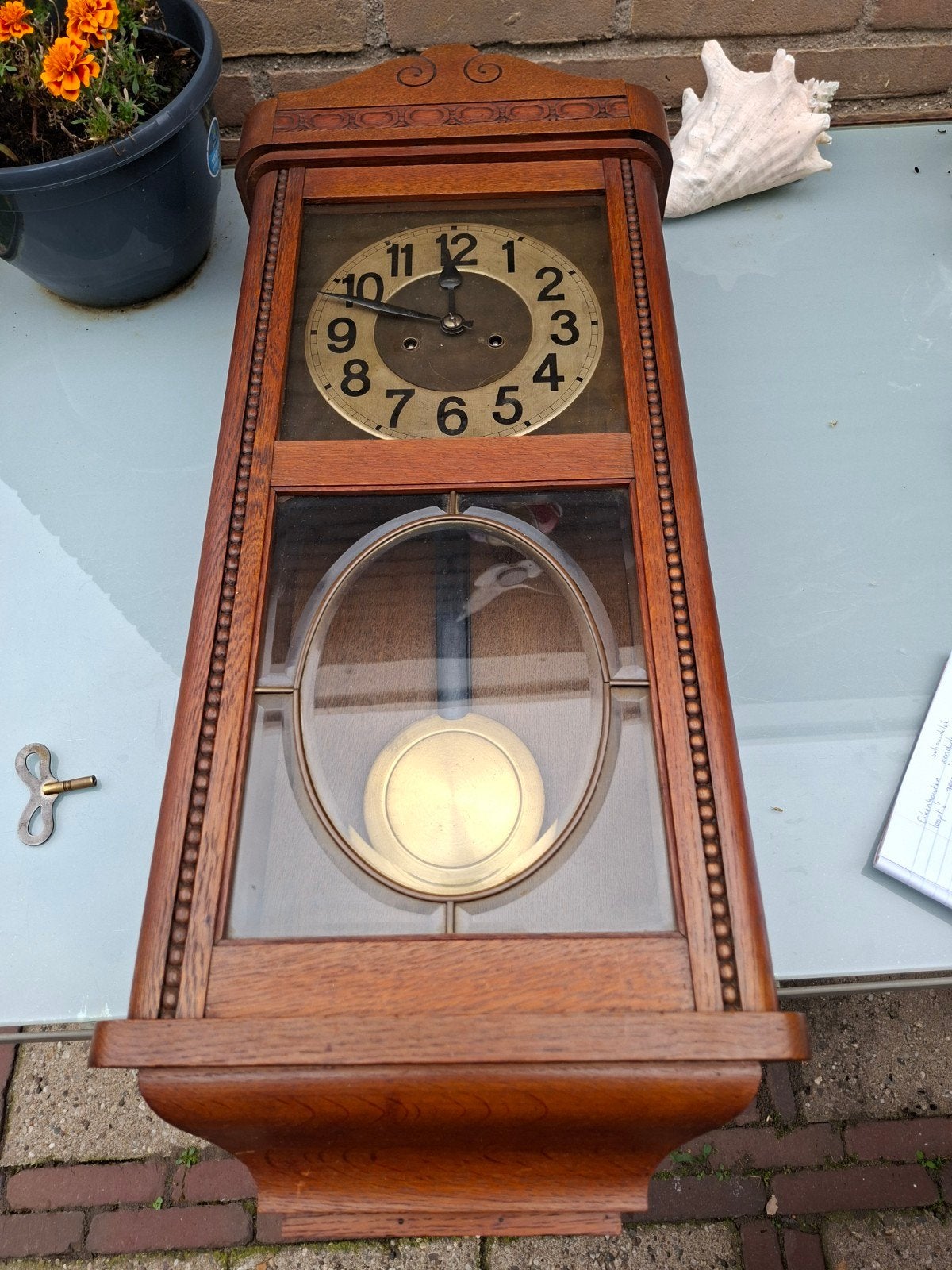 Een Regulator wandklok met slinger, Ophalen