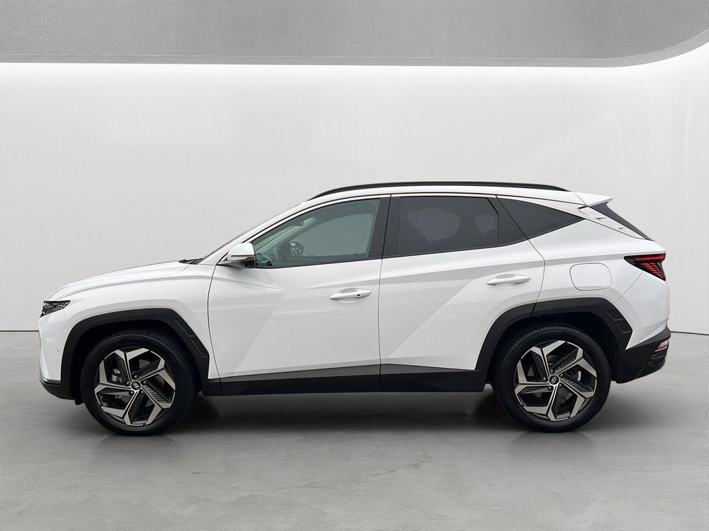 Hyundai Tucson 1.6 T-GDI 265pk PHEV Premium 4WD, Auto's, Gebruikt, 4 cilinders, Wit, Bedrijf