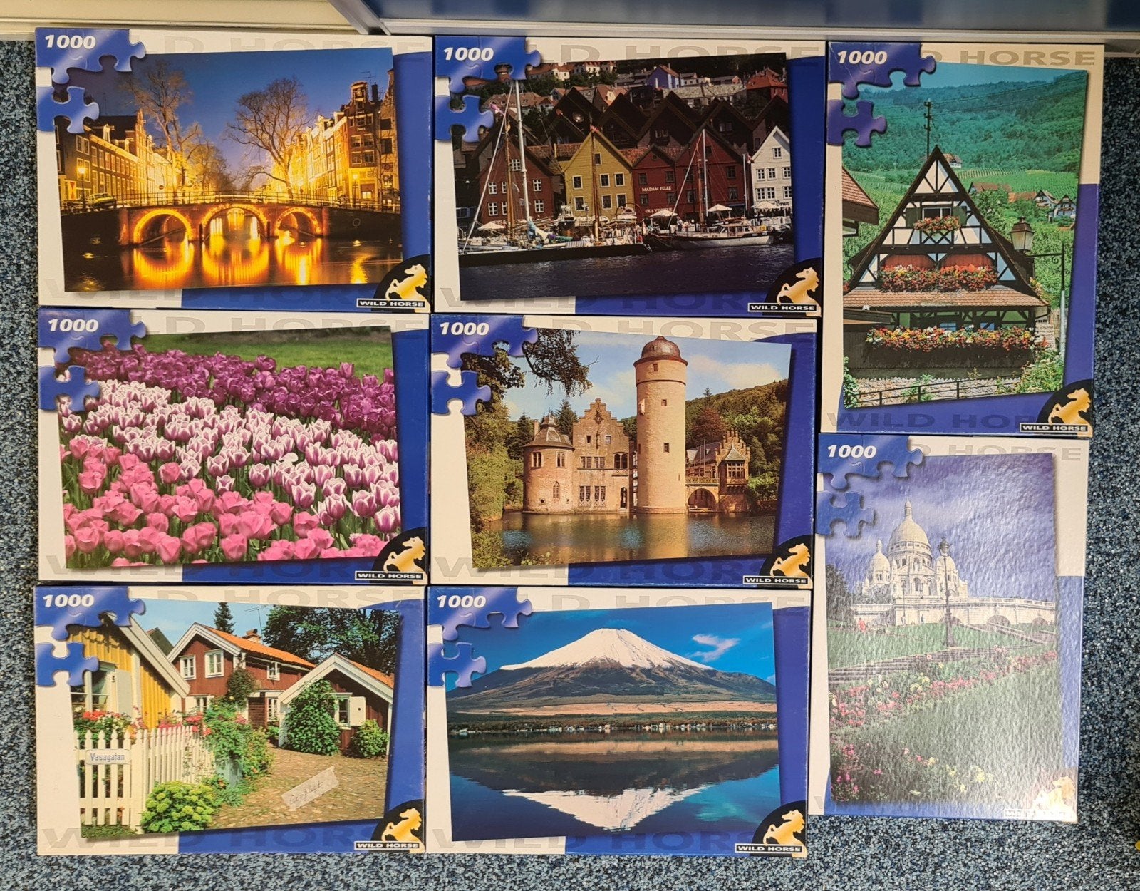 8 blauwe dozen Wildhorse legpuzzels, elk met 1000 stukjes., Ophalen of Verzenden, 500 t/m 1500 stukjes
