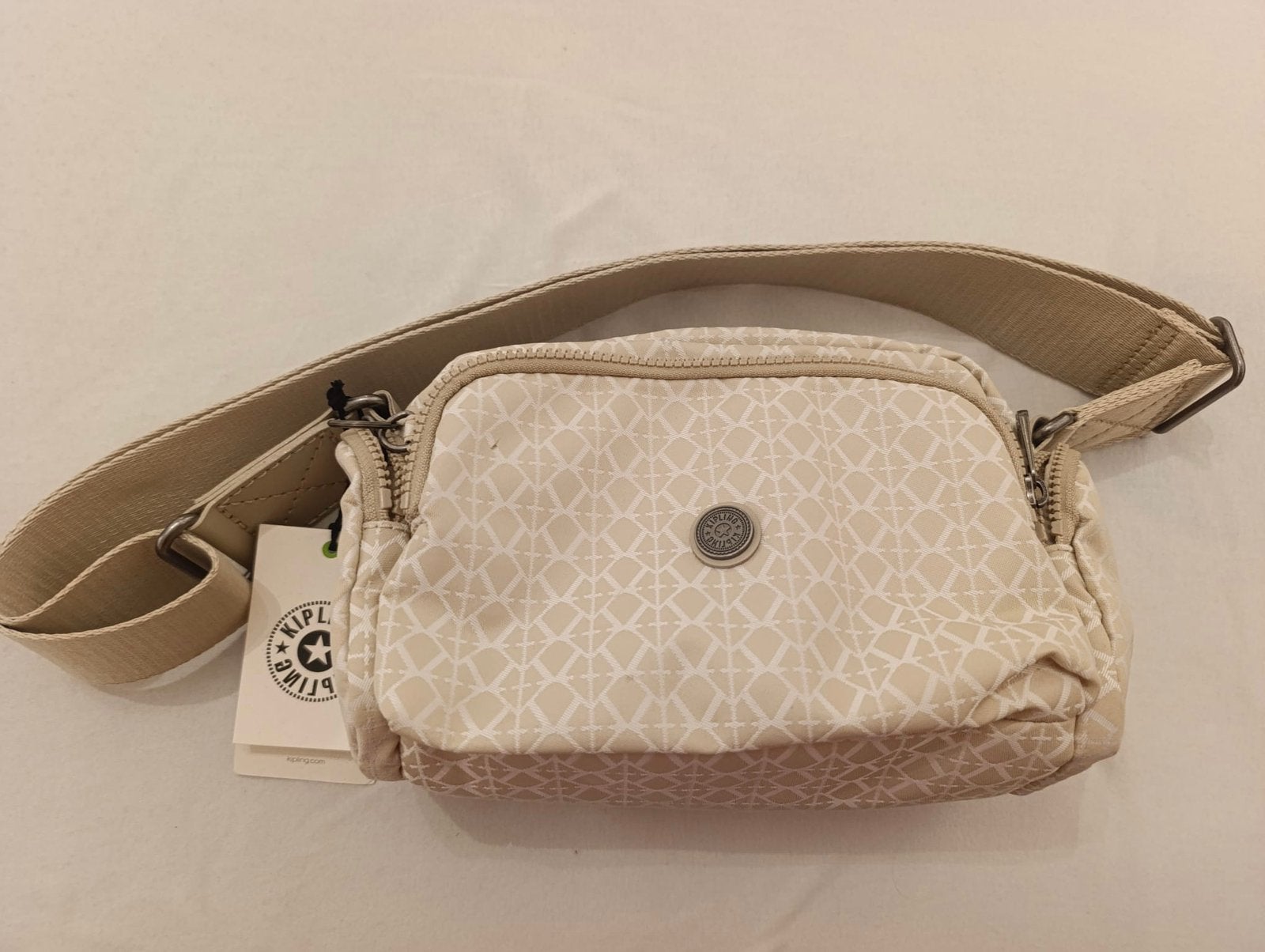 Kipling Jenara S BE schoudertas, nieuw met label, Sieraden, Tassen en Uiterlijk, Ophalen of Verzenden, Nieuw, Beige, Schoudertasje