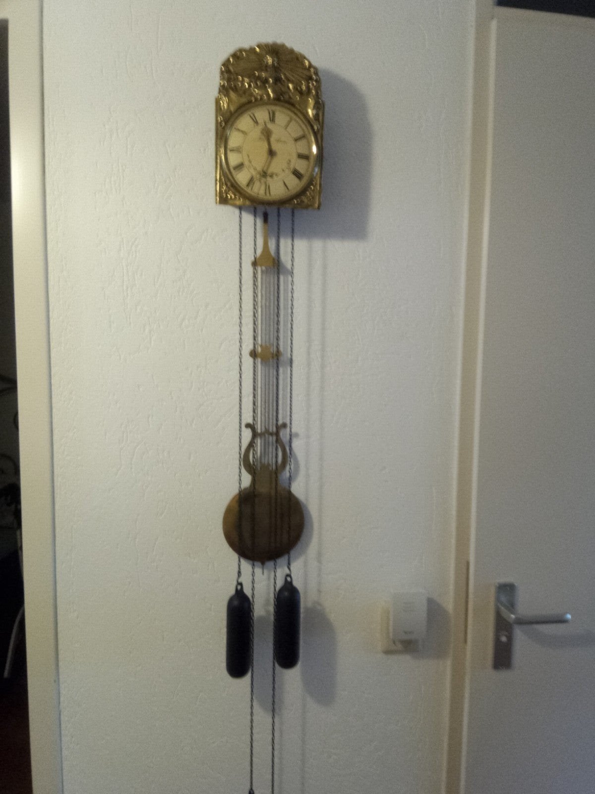 Antieke wandklok met slinger en gewichten, Ophalen