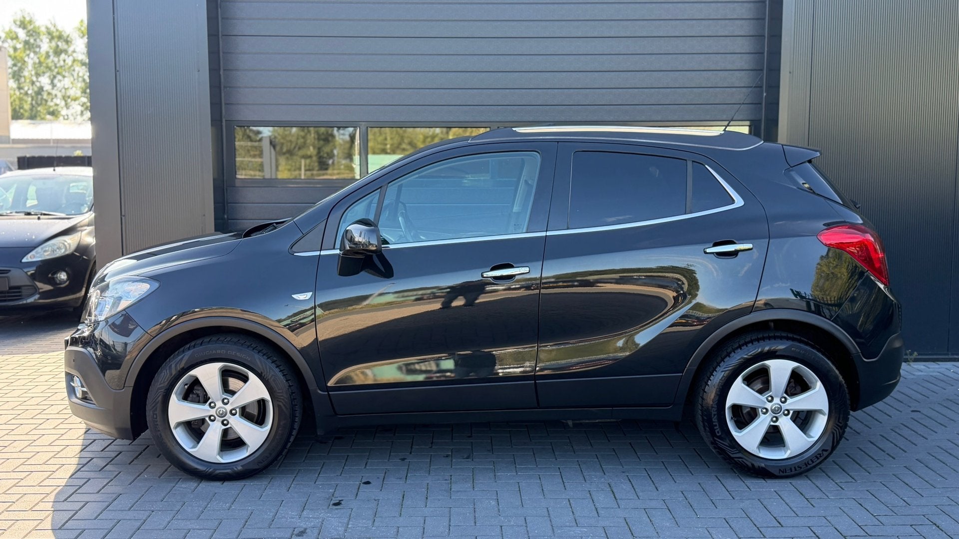 Opel Mokka 1.4 T Cosmo 4x4 Airco|Trekhaak|Cruise|Camera, Auto's, Gebruikt, 4 cilinders, Zwart, Leder