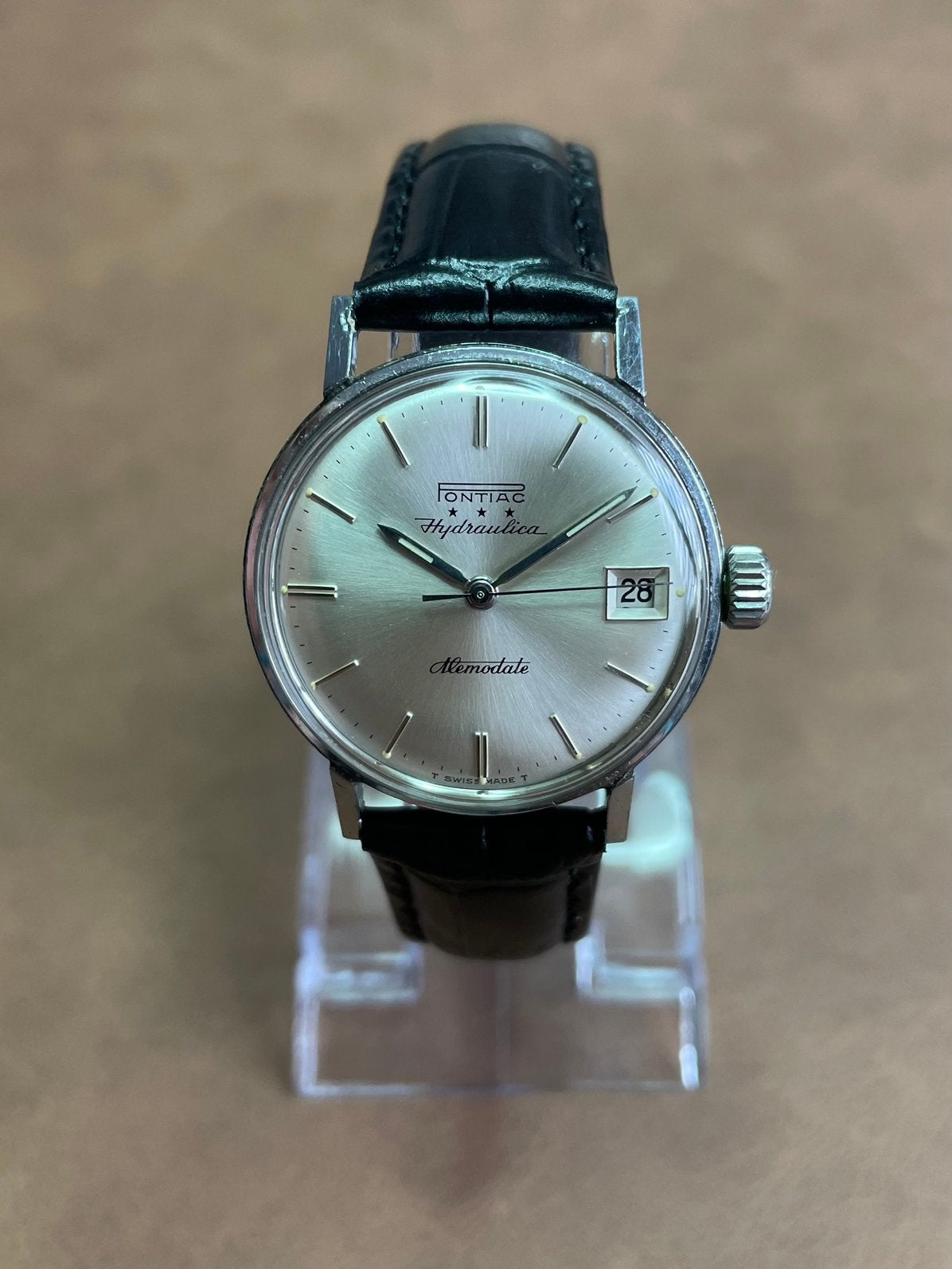 Pontiac Hydraulica Memodate, Sieraden, Tassen en Uiterlijk, Horloges | Antiek, Overige merken, Staal, Polshorloge, 1960 of later
