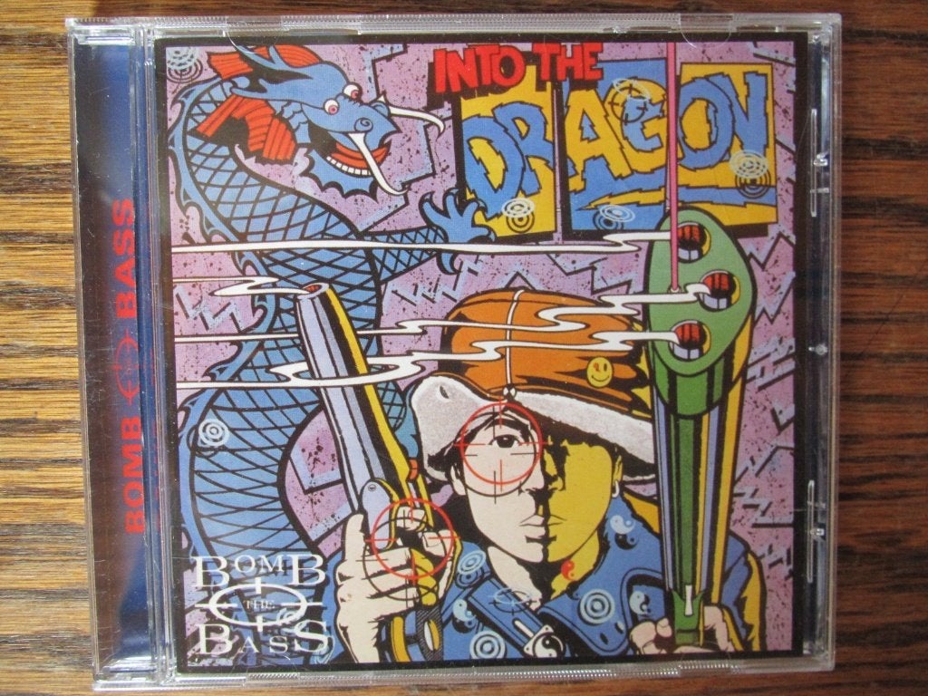 Into The Dragon + bonus tracks - Bomb The Bass, Met bonustracks, Pop, Ophalen of Verzenden, Zo goed als nieuw