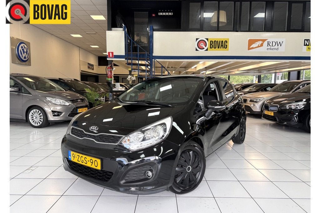 Kia Rio 1.2 CVVT Executive Bovag Garantie NAP (bj 2015), 21 km/l, Parkeersensor, 4 cilinders, Zwart