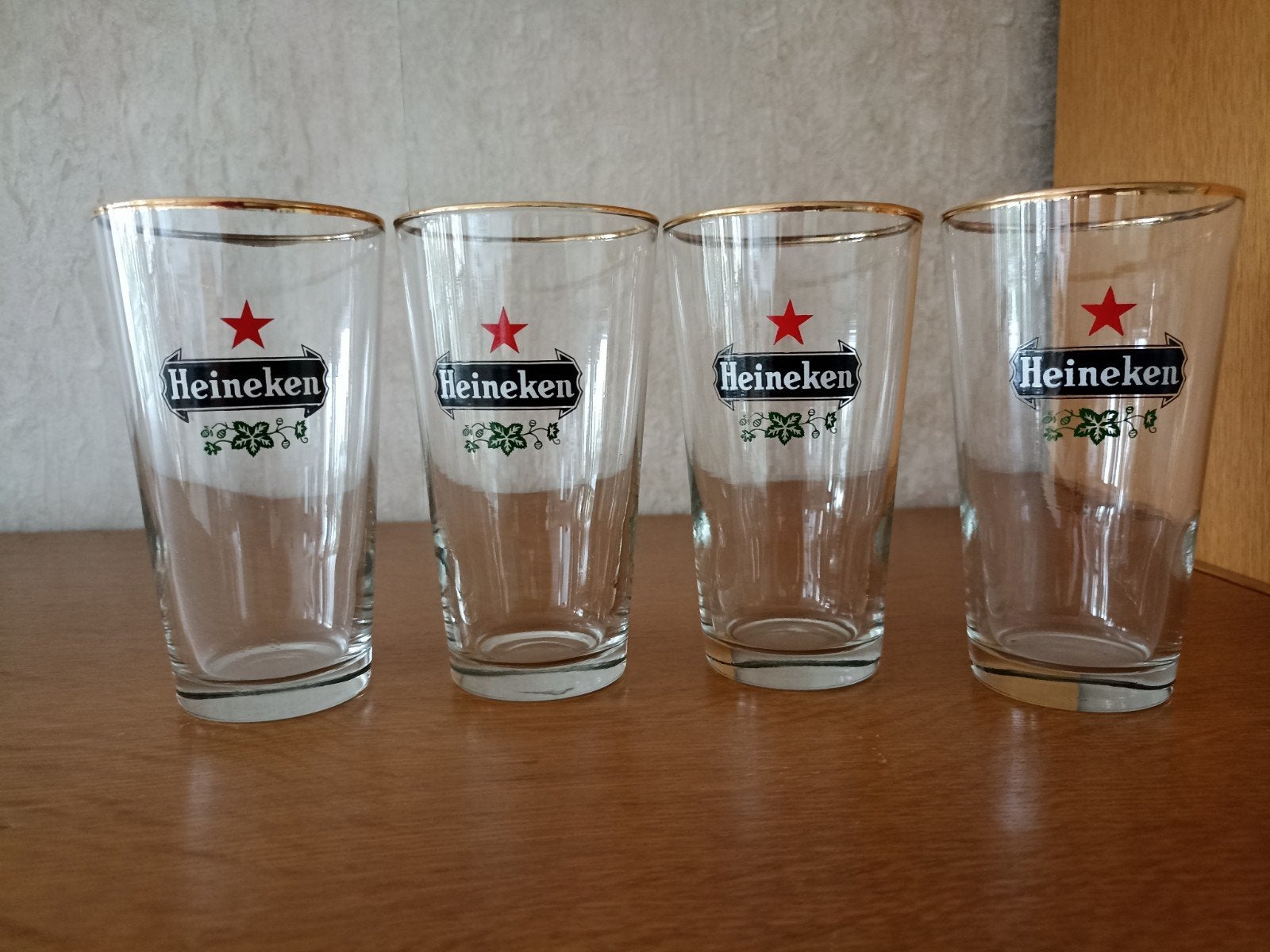 Set van 4 Heineken bierglazen, Ophalen of Verzenden, Zo goed als nieuw, Bierglas