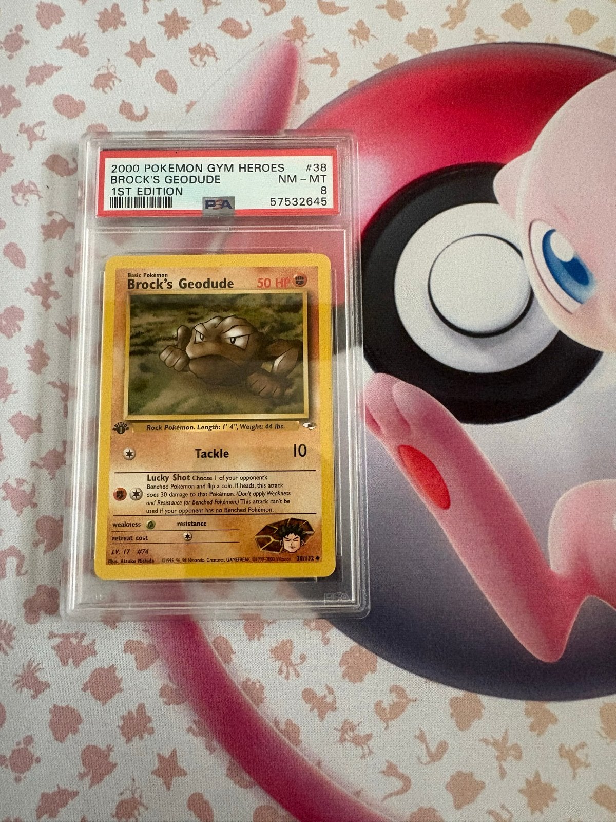 PSA 8 Brock's Geodude 1st Edition Gym Heroes Pokémon Kaart, Ophalen of Verzenden, Zo goed als nieuw, Losse kaart