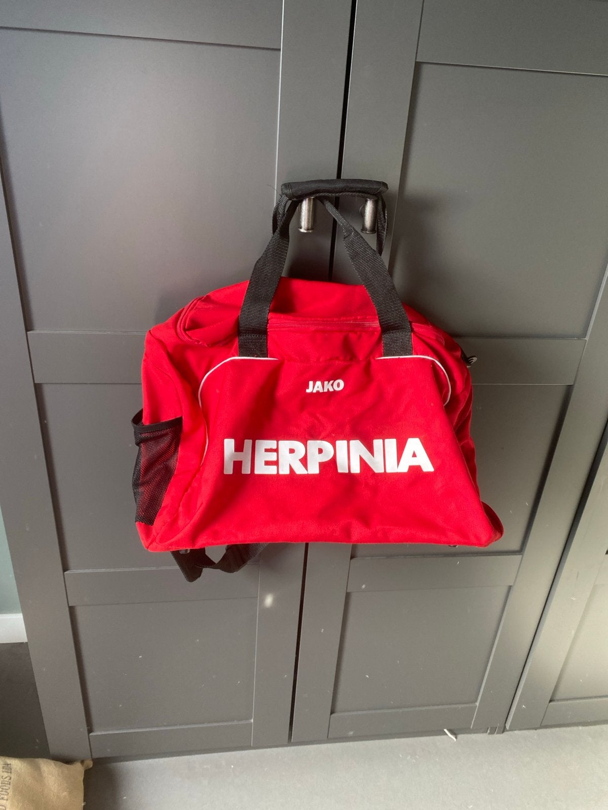 Jako Voetbaltas Rood - Herpinia Opdruk, Ophalen of Verzenden, Gebruikt, Overige typen
