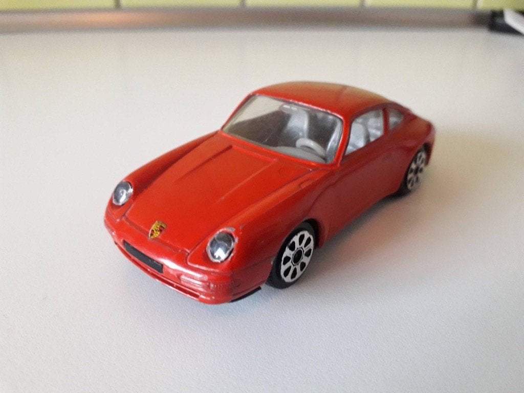 porsche 911 carrera            burago, Hobby en Vrije tijd, Modelauto's | 1:43, Ophalen of Verzenden, Gebruikt, Auto, Overige merken