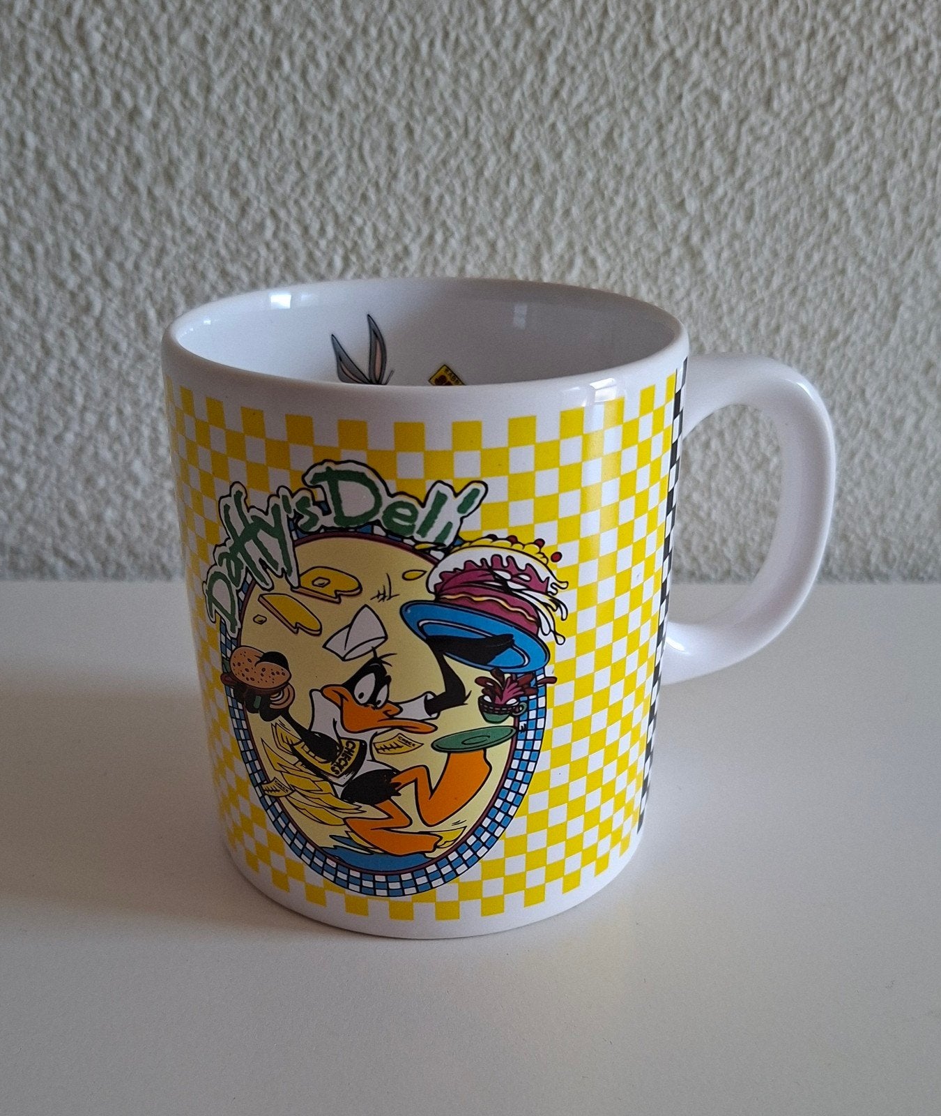 Loony Tunes Daffy Duck beker. "Daffy's Deli". 250 ml., Gebruikt, Overige stijlen, Aardewerk, Mok