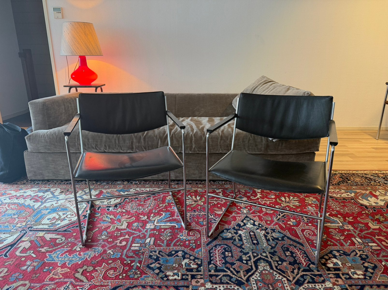 Twee zwart leren Arnold Merckx stoelen, Ophalen, Zo goed als nieuw
