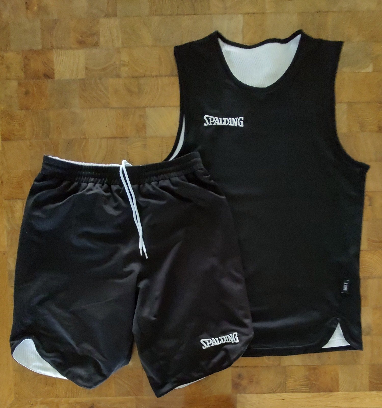 Spalding basketbal tenue S - omkeerbaar (zwart/wit)