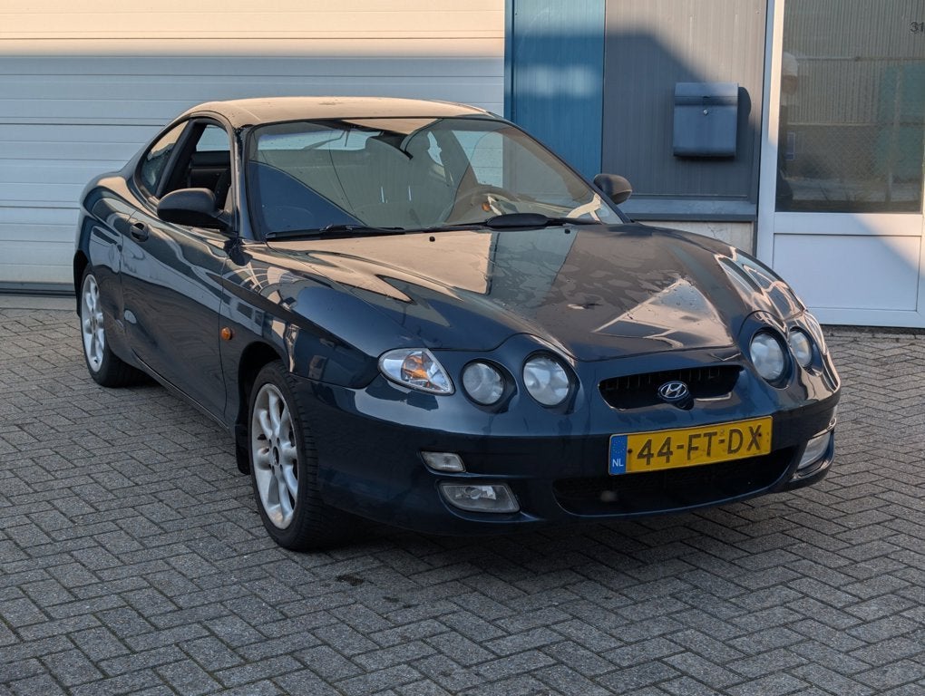Hyundai Coupé 2.0i F Coupe Lage Km NAP, Auto's, Voorwielaandrijving, Stof, Gebruikt, Bedrijf