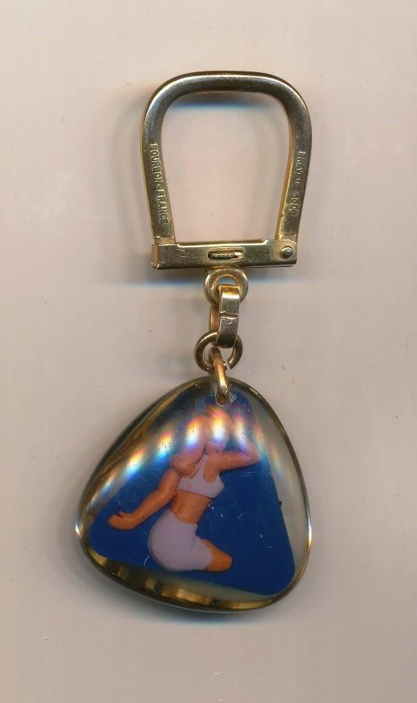 Vintage DEWE International. Pinup girl Bourbon sleutelhanger, Verzenden, Gebruikt, Merk