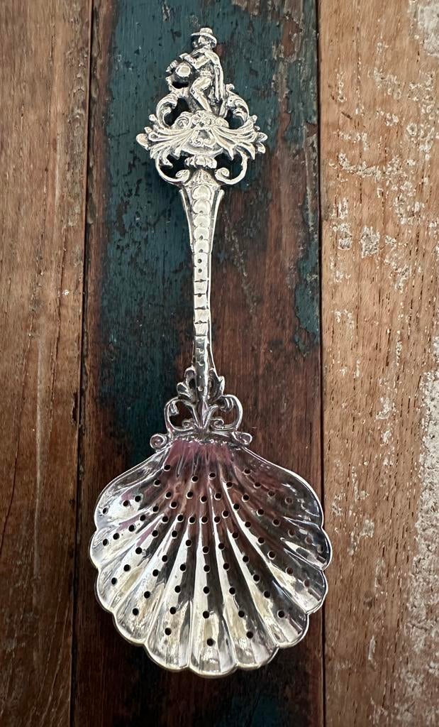 Antiek geperforeerde suikerstrooilepel schelp pelgrimfiguur, Ophalen of Verzenden, Zilver
