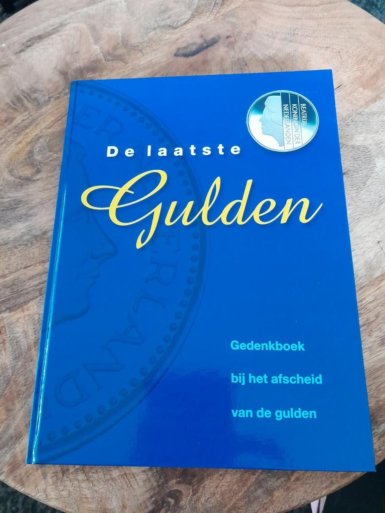 Boek "De laatste Gulden" met echte guldens, Ophalen of Verzenden