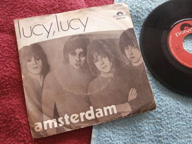 Amsterdam - Lucy Lucy., 7 inch, Zo goed als nieuw, Pop, Fotohoes