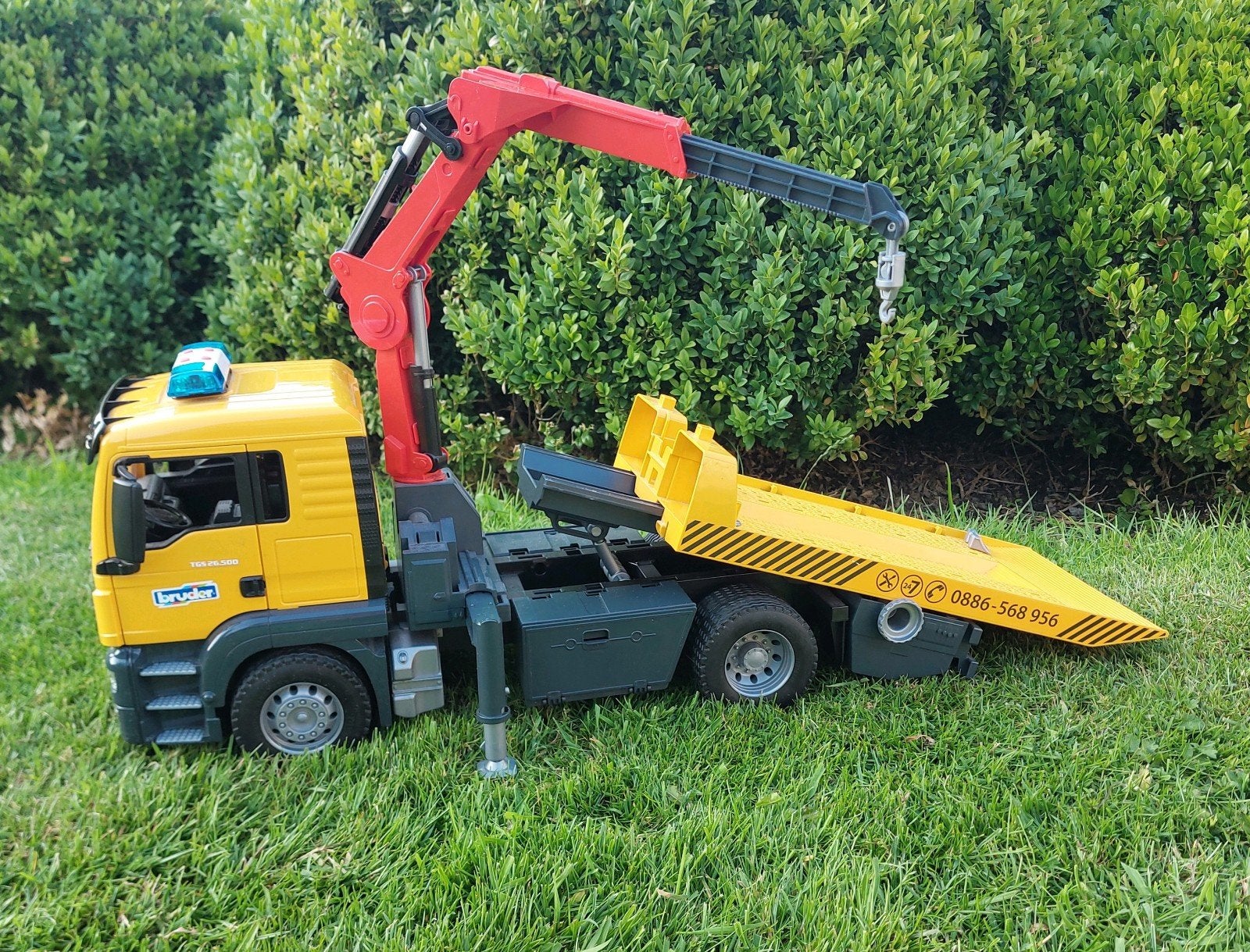 Bruder MAN TGA Takelwagen met Kraan en Licht & Geluid, Ophalen