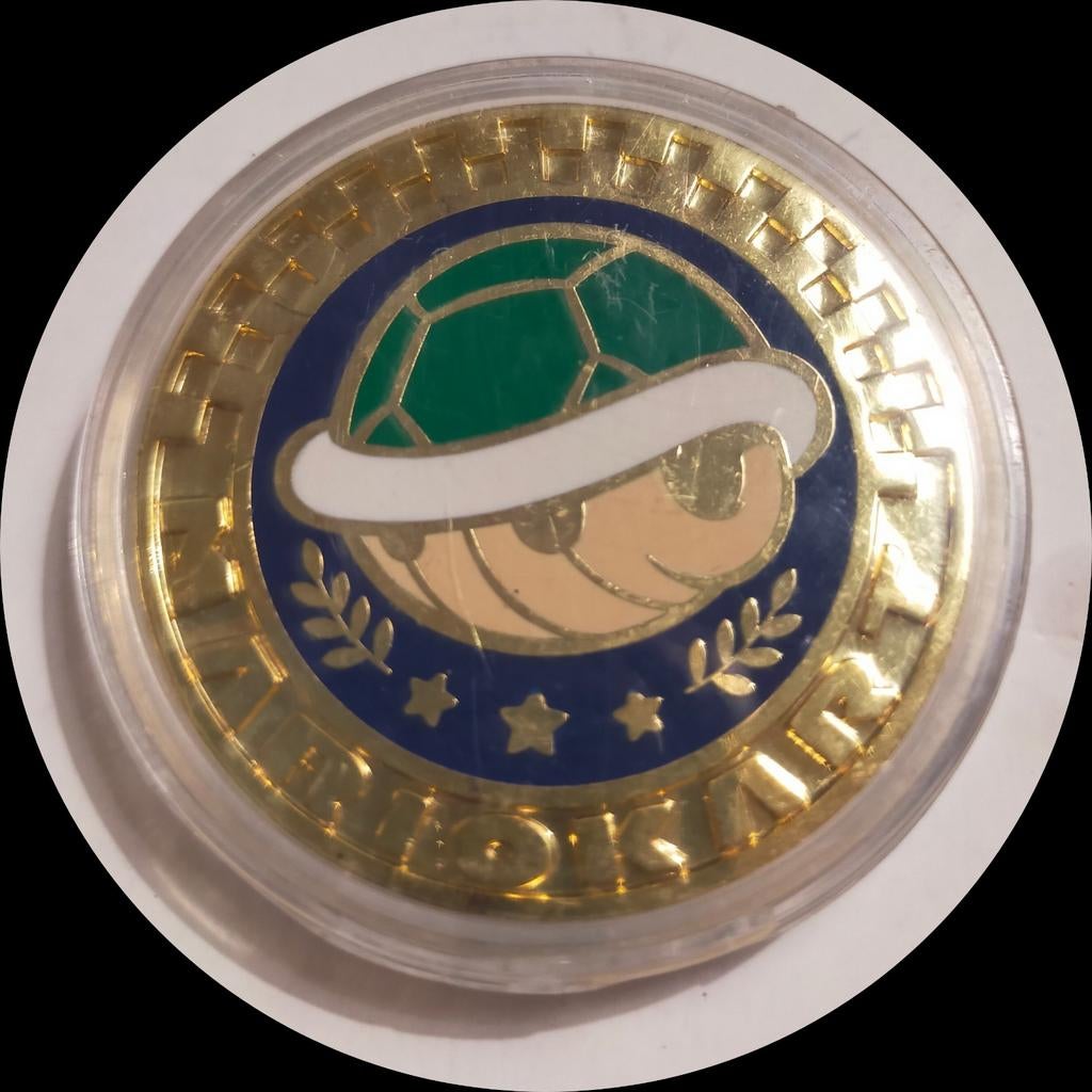 Mario Kart Shell Cup-munt. Goudkleurig metaal., Verzamelen, Supermarktacties, Plus, Ophalen of Verzenden