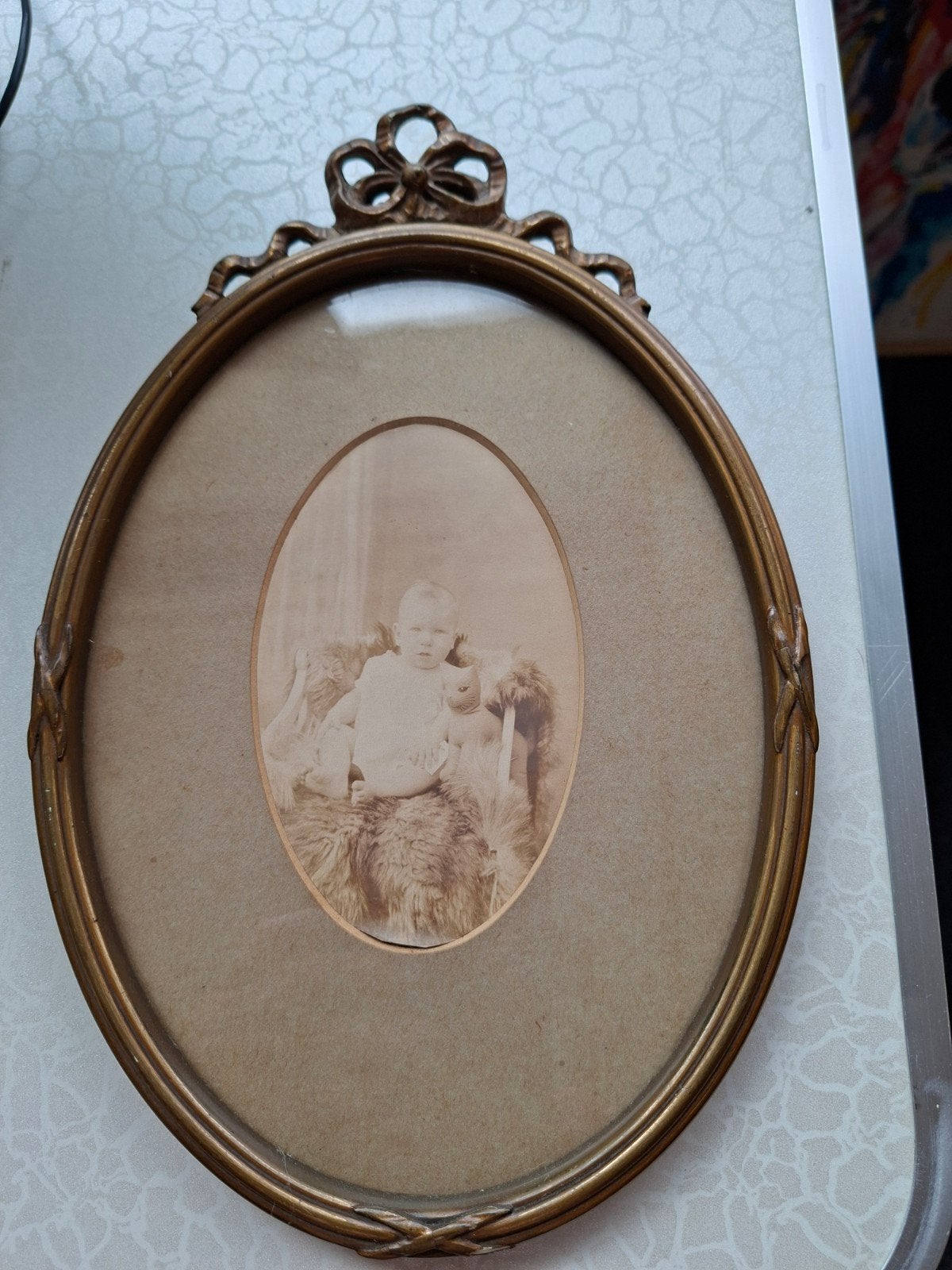 oud goudkleurig ovaal fotolijstje, Ophalen