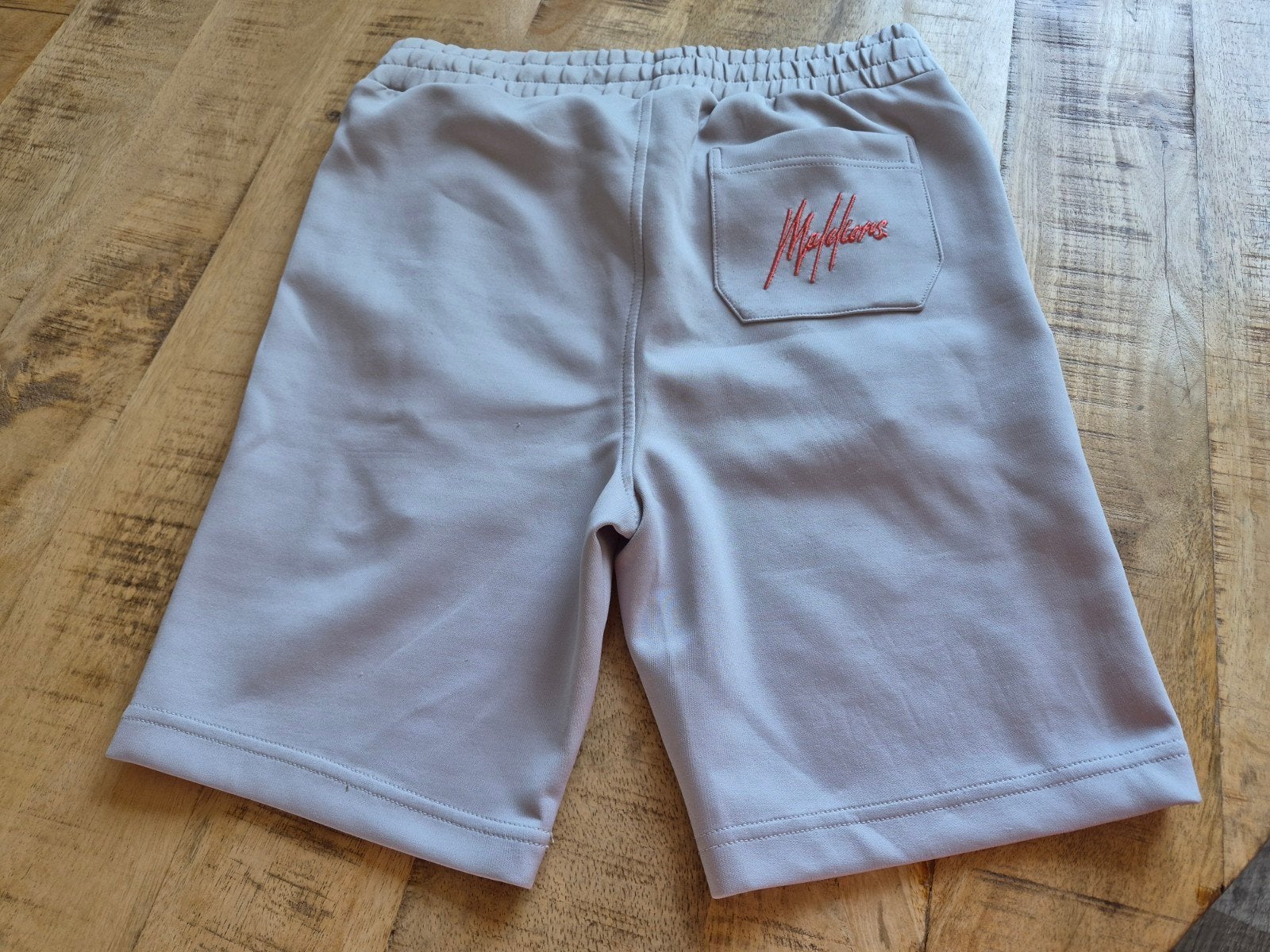 Malelions Sportshort Grijs/Oranje - Maat M, Kleding | Heren, Fitness, Maat 48/50 (M), Malelions, Ophalen of Verzenden