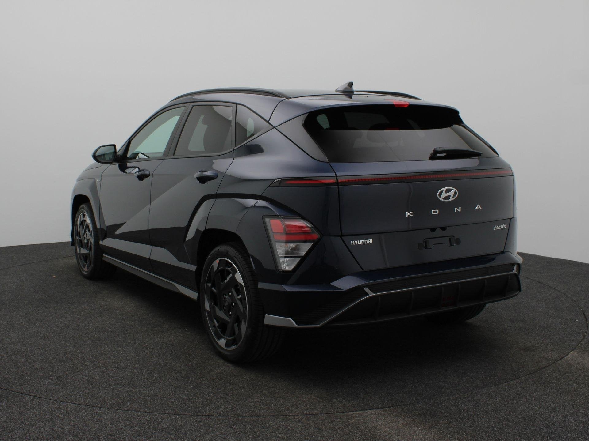 Hyundai Kona Electric N Line Business 64.8 kWh | Warmtepomp, Auto's, Stof, Zwart, Met garantie (alle), Blauw