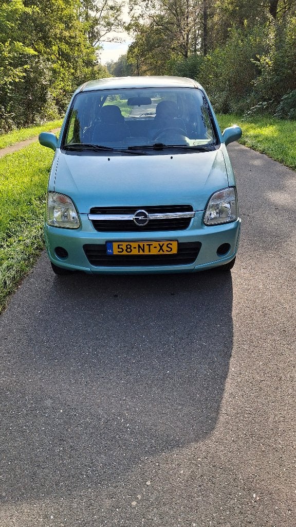 Opel Agila 1.2 I 16V 2004 licht blauw, Auto's, Voorwielaandrijving, Dealer onderhouden, Stof, Handgeschakeld