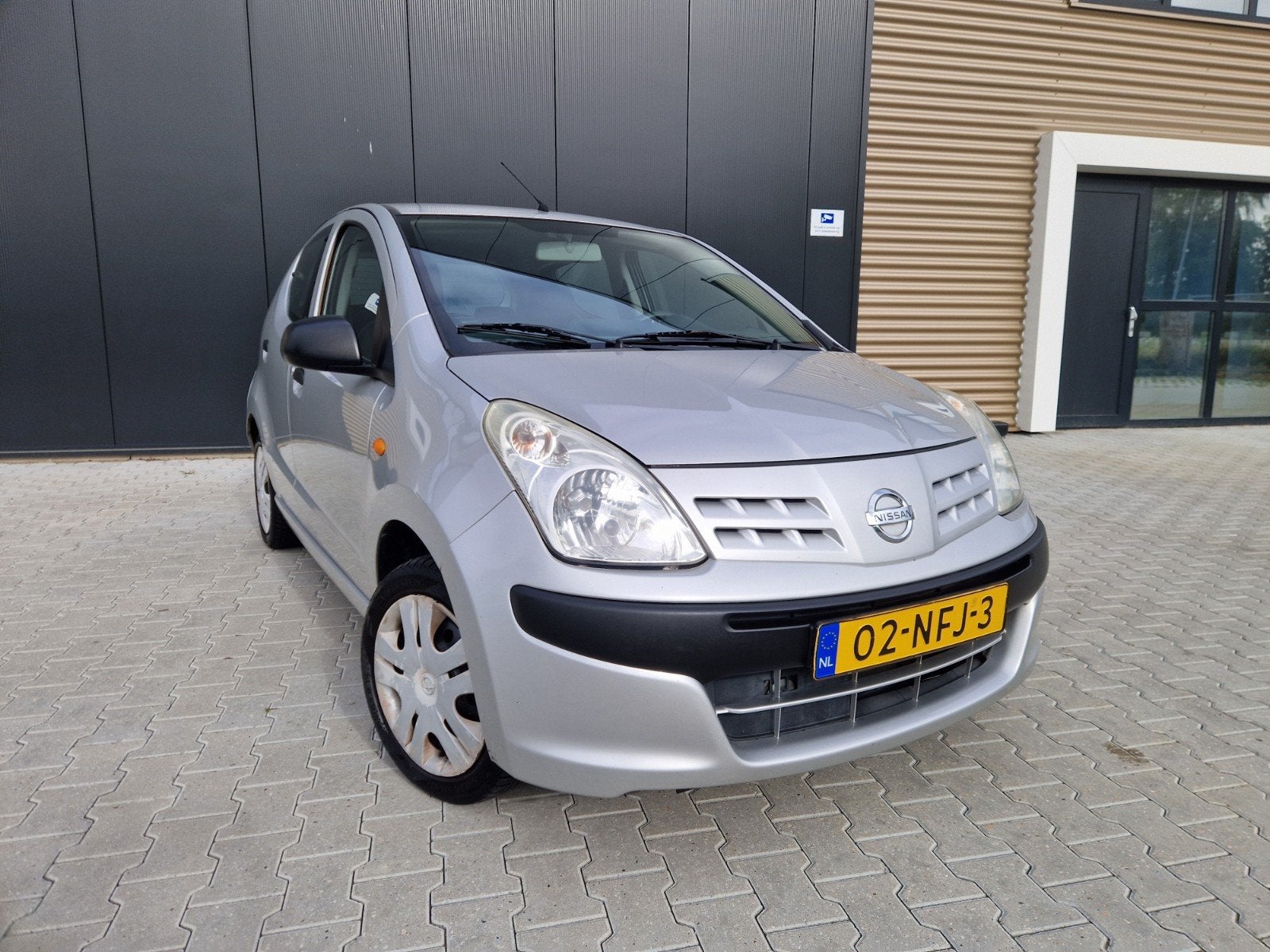 Nissan Pixo 1.0 50KW 5D 2010 Grijs, Auto's, Voorwielaandrijving, Stof, 4 stoelen, Origineel Nederlands